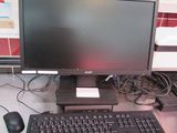 an image of a computer desk with a keyboard and monitor