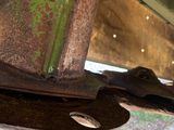 a close up of a rusted metal object on the side of a building