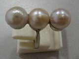 three white pearls are sitting on top of a white surface