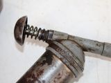 a rusted pipe that has a wren on top of it
