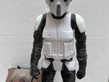 a star wars action figure that is standing next to a toy car