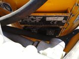 a close up of a yellow machine with a black hose
