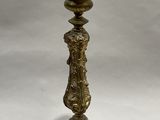 brass candle holder with a cone on top of it on a white background
