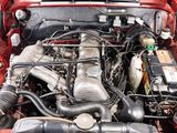 a red car with its engine in the trunk