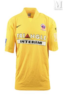 a close up of a yellow shirt with the word triangle interim on it
