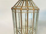 an antique brass and glass lantern hanging from a ceiling