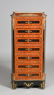 an image of a small chest of drawers with gold trimmings