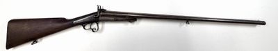 rifle mounted on a wall in a room with a white wall
