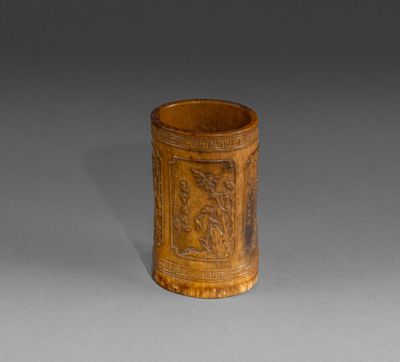 an old wooden cup with a design on it