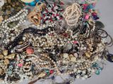 a pile of assorted jewelry sitting on a table