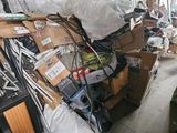 a large pile of boxes and wires on the floor