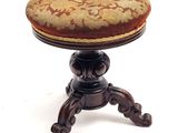 a small wooden stool with a cushion on top of it