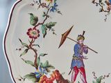 a plate with a picture of a man on a boat