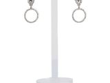a close up of a pair of earrings on a stand