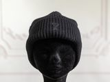 a mannequin head wearing a black hat with a star on it