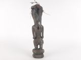 an image of a statue of a man with a bird on top of his head