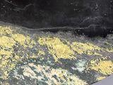 yellow and black marble table top with wooden legs