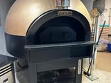 an image of a wood fired pizza oven in a kitchen