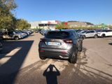 cars parked in a parking lot with a shadow of a person on the ground