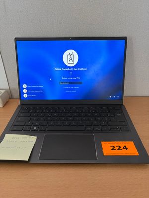 a laptop that is sitting on a desk with a price tag