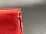 red leather wallet with red stitching on the inside