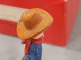 toy figurine of a man with a cowboy hat and boots on a skateboard