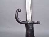 a close up of a sword on a stand