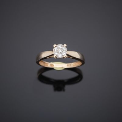 a single stone diamond ring on a black surface
