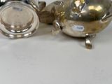 a silver tea pot and a silver teapot on a table