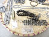 a basket with many different types of jewelry on it