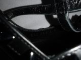 a close up of a pair of black shoes on a table