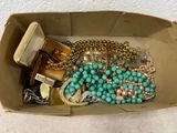 a box with a bunch of jewelry inside of it
