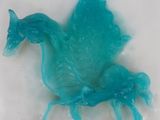a blue plastic horse that is sitting on a table