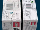 two boxes of legos sitting side by side on a table