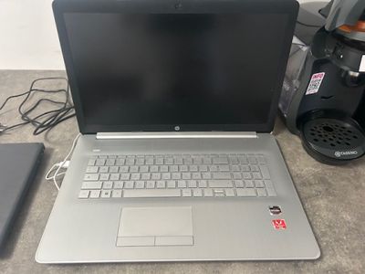 a laptop that is sitting on the floor next to a cell phone