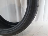 a close up of a tire on a white background with a white curtain
