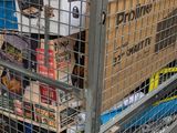 a metal cart with boxes on top of it on the street