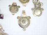 five pieces of jewelry on a table with a white background
