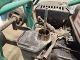 a close up of a small engine on a green bike