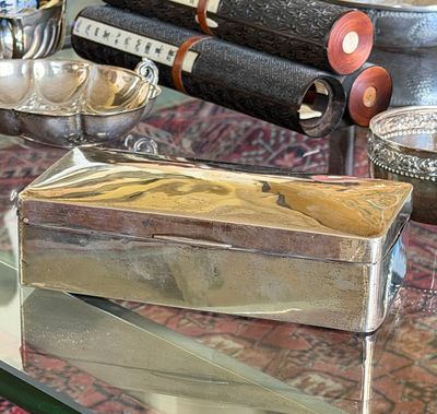 a glass table with a silver box on top of it