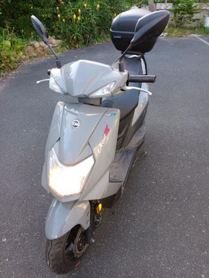 a scooter that is parked on the side of the road