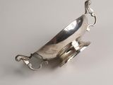 a silver plate with a horse on it on a white surface