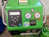 a green machine that is sitting on the ground