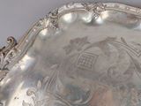 a silver tray with a design on it on a table