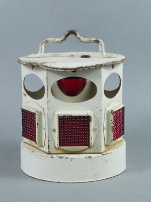 a small white box with a red and white design on it