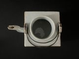 a cup of coffee sitting on top of a white box
