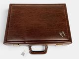 a brown briefcase sitting on top of a white surface