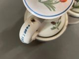 a close up of a cup and saucer on a table