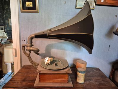 a wooden table topped with a gramphone and a plate on it