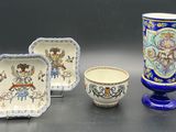 three different pieces of pottery sitting on a table